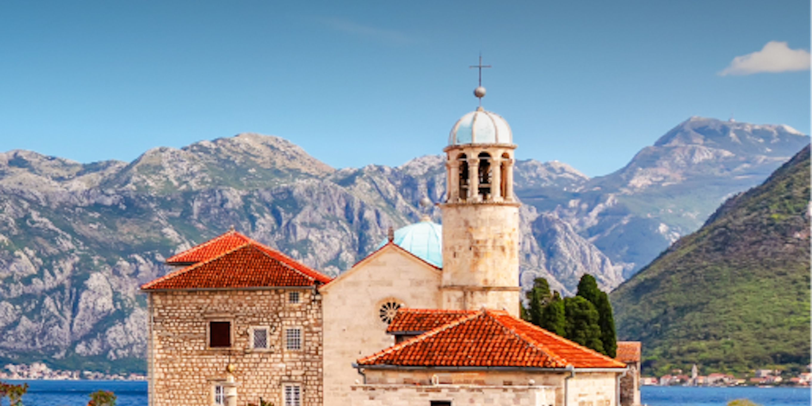 Tivat City waterfront with boats and mountains in Montenegro.