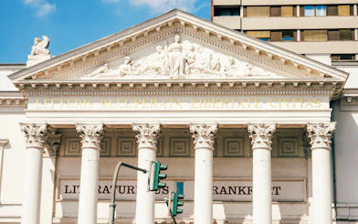 Facade of Literature House in Frankfurt with classical columns and Latin inscription.