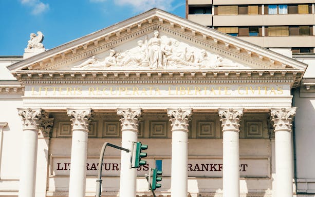Facade of Literature House in Frankfurt with classical columns and Latin inscription.