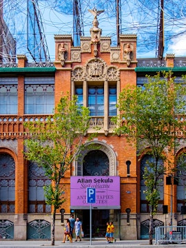 Fundació Antoni Tàpies entrance with decorative facade and exhibition sign in Barcelona.