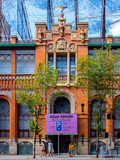 Fundació Antoni Tàpies entrance with decorative facade and exhibition sign in Barcelona.