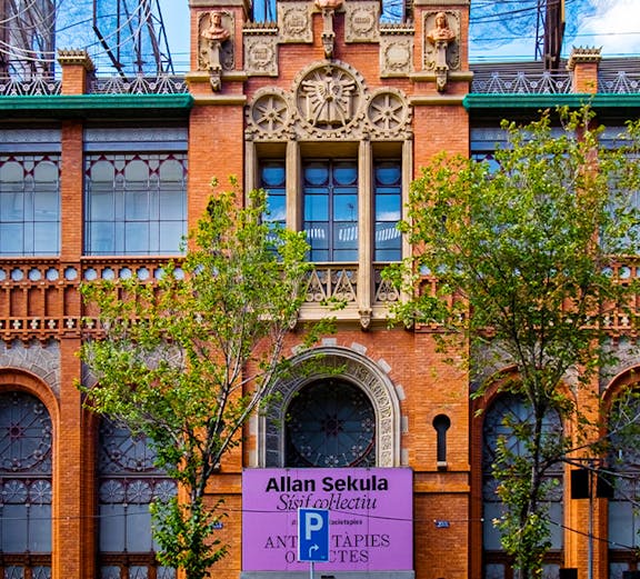 Fundació Antoni Tàpies entrance with decorative facade and exhibition sign in Barcelona.