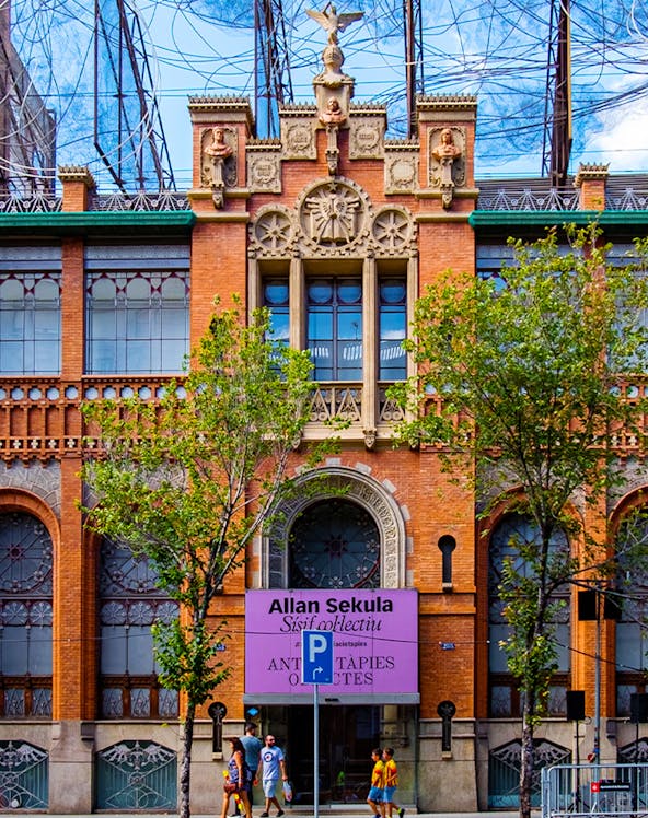 Fundació Antoni Tàpies entrance with decorative facade and exhibition sign in Barcelona.