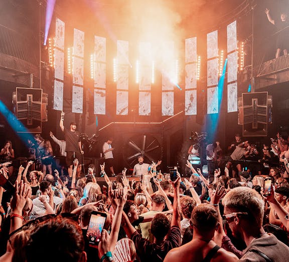 Crowd enjoying a DJ performance at Eden Ibiza nightclub.