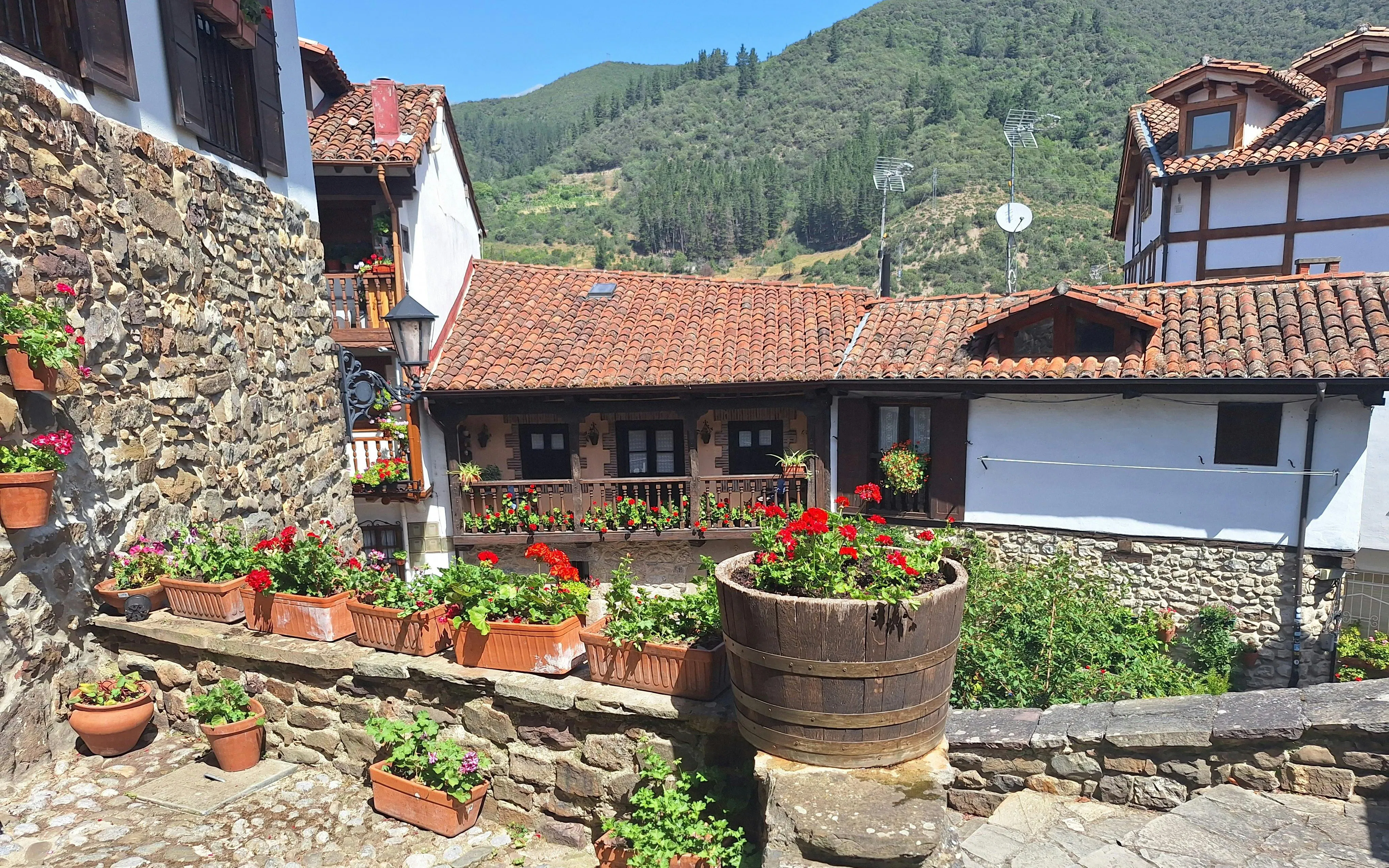 Traditional stone and timber houses with flower boxes in Potes, Cantabria, Spain.