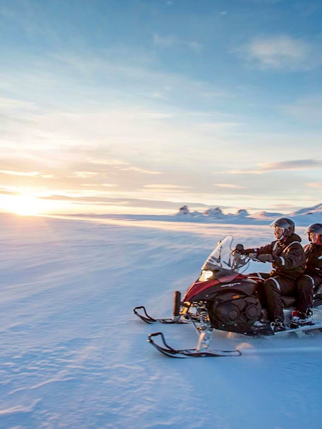 Snowmobiling on a glacier during Secret Lagoon hot spring tour in Iceland.