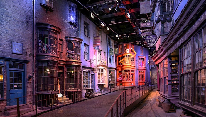 Diagon Alley at Harry Potter Exhibit featuring Ollivanders and colorful shopfronts.