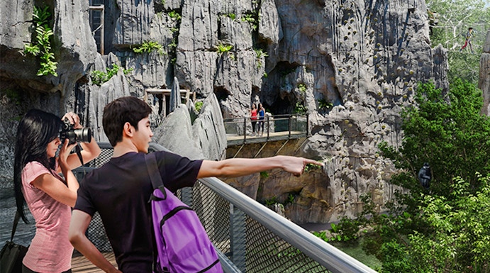 Visitors on a walkway exploring rocky terrain in Rainforest Wild Asia.