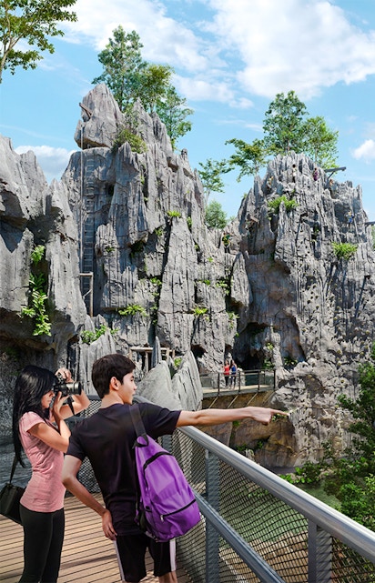 Visitors on a walkway exploring rocky terrain in Rainforest Wild Asia.