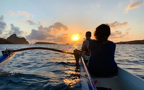 Boat ride at sunset near Noronha, with passengers enjoying the view, Sao Paulo.
