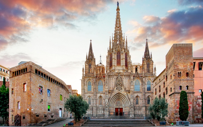 Barcelona Cathedral facade with spires at sunset, part of guided tour with terrace access.
