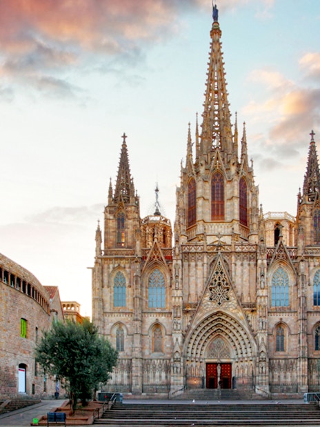 Barcelona Cathedral facade with spires at sunset, part of guided tour with terrace access.