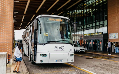 Passenger boarding bus at Treviso Airport terminal.