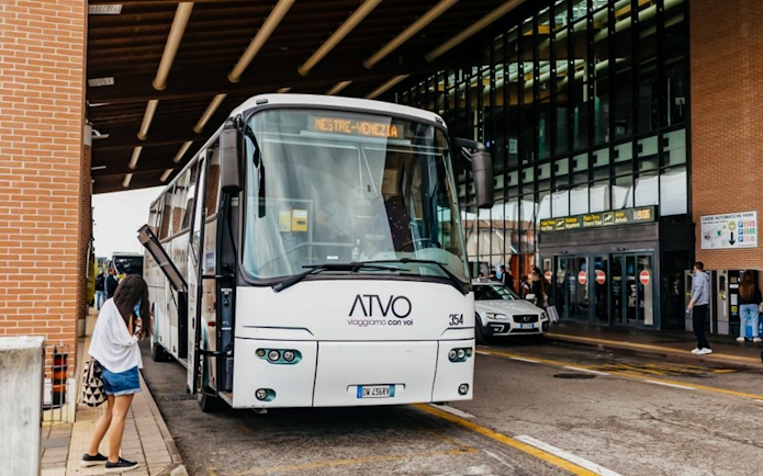 Passenger boarding bus at Treviso Airport terminal.