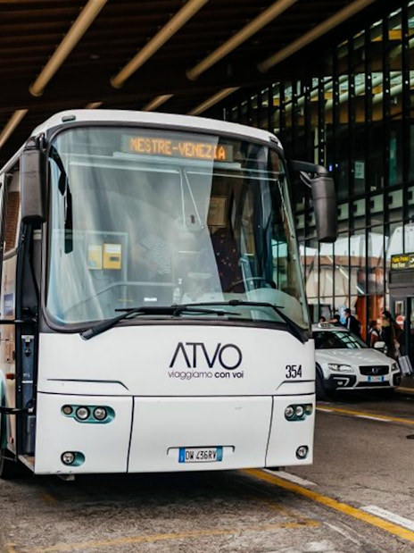 Passenger boarding bus at Treviso Airport terminal.