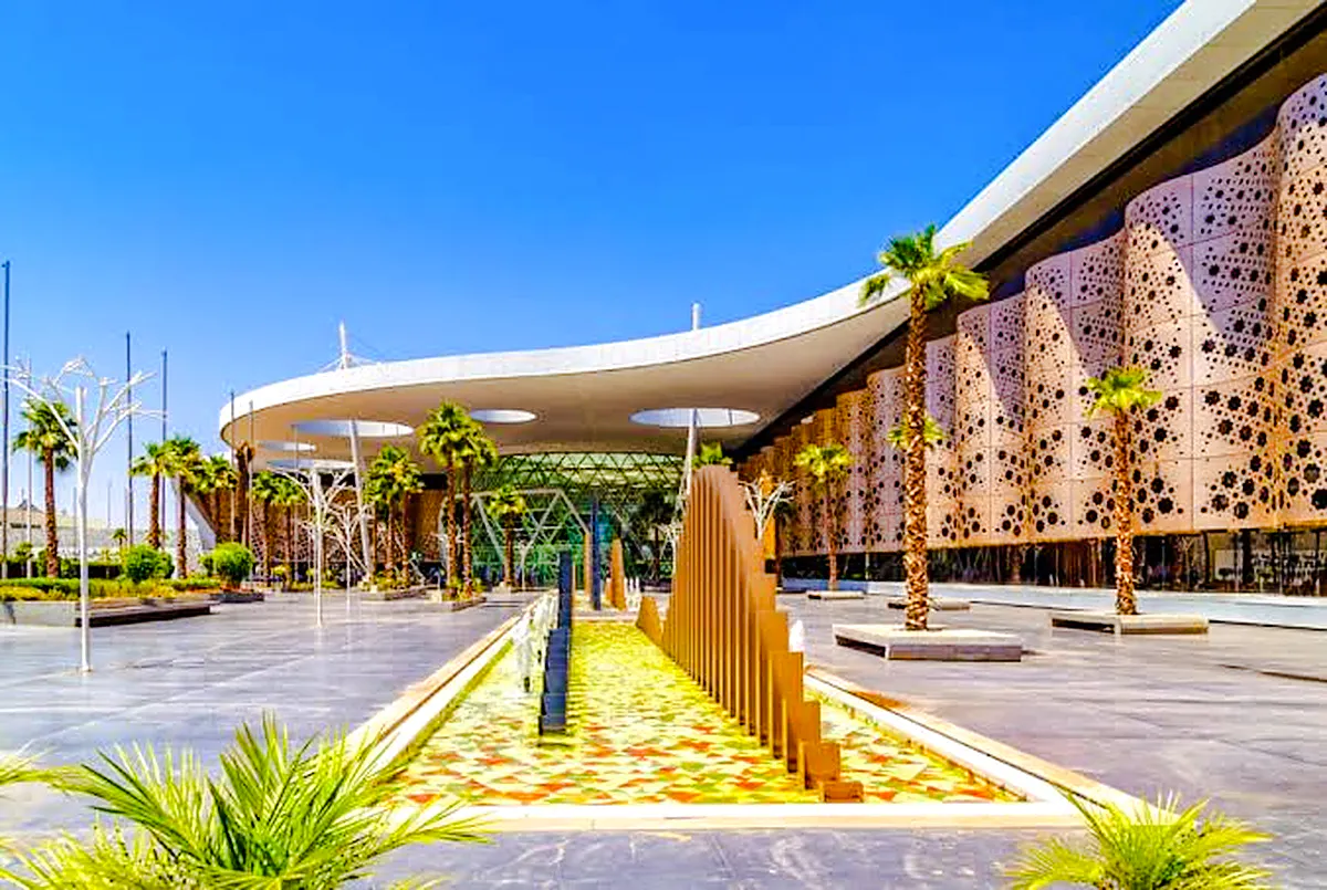 Marrakech Menara Airport exterior with modern architecture and palm trees.