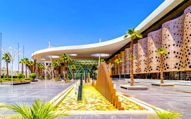 Marrakech Menara Airport exterior with modern architecture and palm trees.