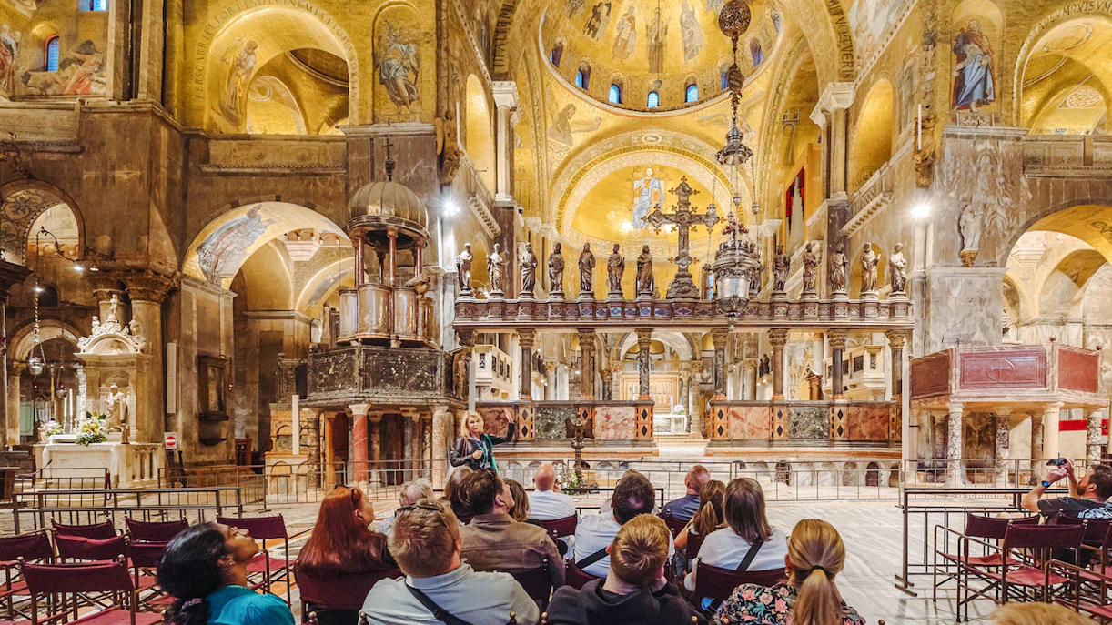 Tour group inside St. Mark's Basilica, Venice, admiring ornate interior after hours.