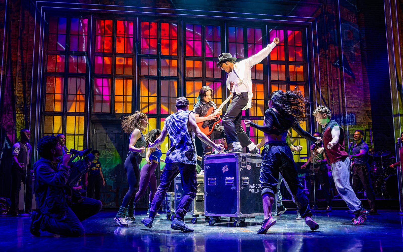 Stage performance of MJ the Musical in Brisbane with dancers and vibrant backdrop.