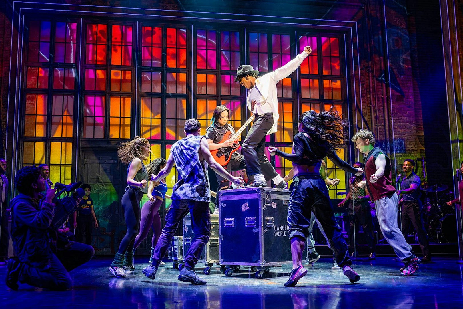 Stage performance of MJ the Musical in Brisbane with dancers and vibrant backdrop.