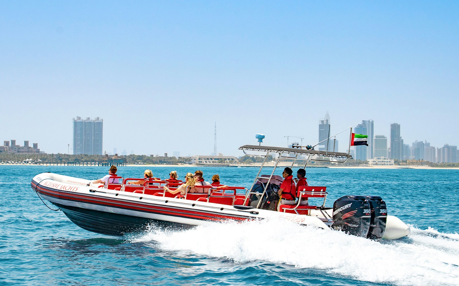 Speedboat cruising past Dubai Marina with views of Atlantis and Burj Al Arab.
