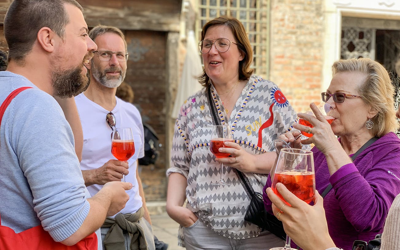 Group enjoying spritz cocktails on a Venice tour.