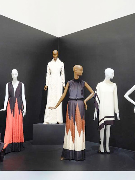 Mannequins displaying Martin Grant fashion exhibits with black and white dresses.