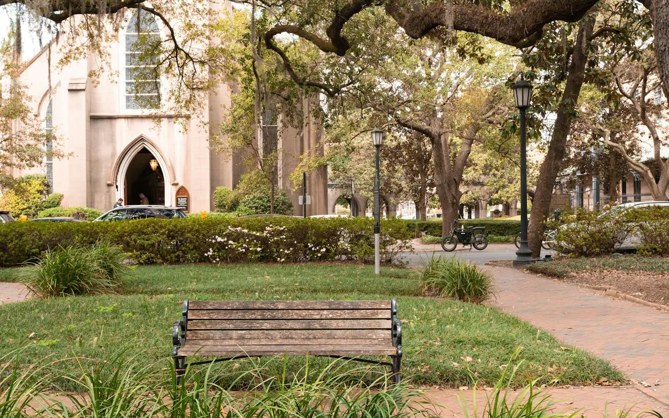 Historic church and park bench in Savannah, Georgia, part of the Ghosts of Savannah exploration game.