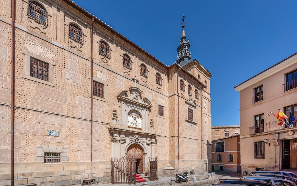 Royal College of Noble Maidens facade in Toledo, Spain, with ornate entrance and historic architecture.