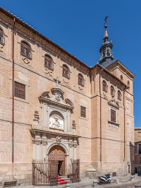 Royal College of Noble Maidens facade in Toledo, Spain, with ornate entrance and historic architecture.