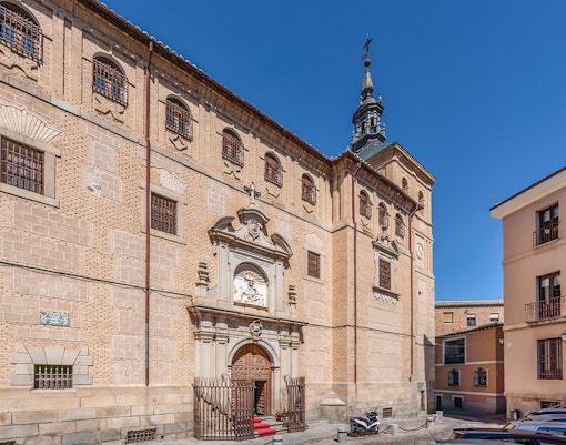 Royal College of Noble Maidens facade in Toledo, Spain, with ornate entrance and historic architecture.