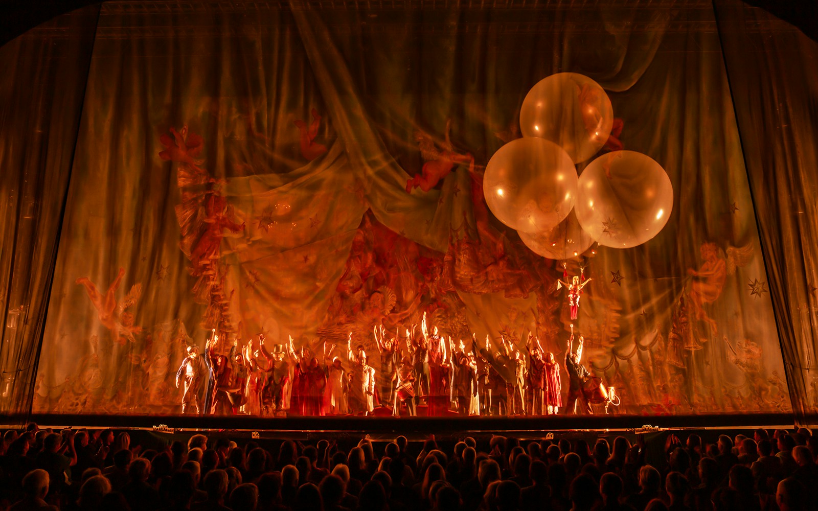 Cirque du Soleil performers in vibrant costumes on stage during Corteo show.