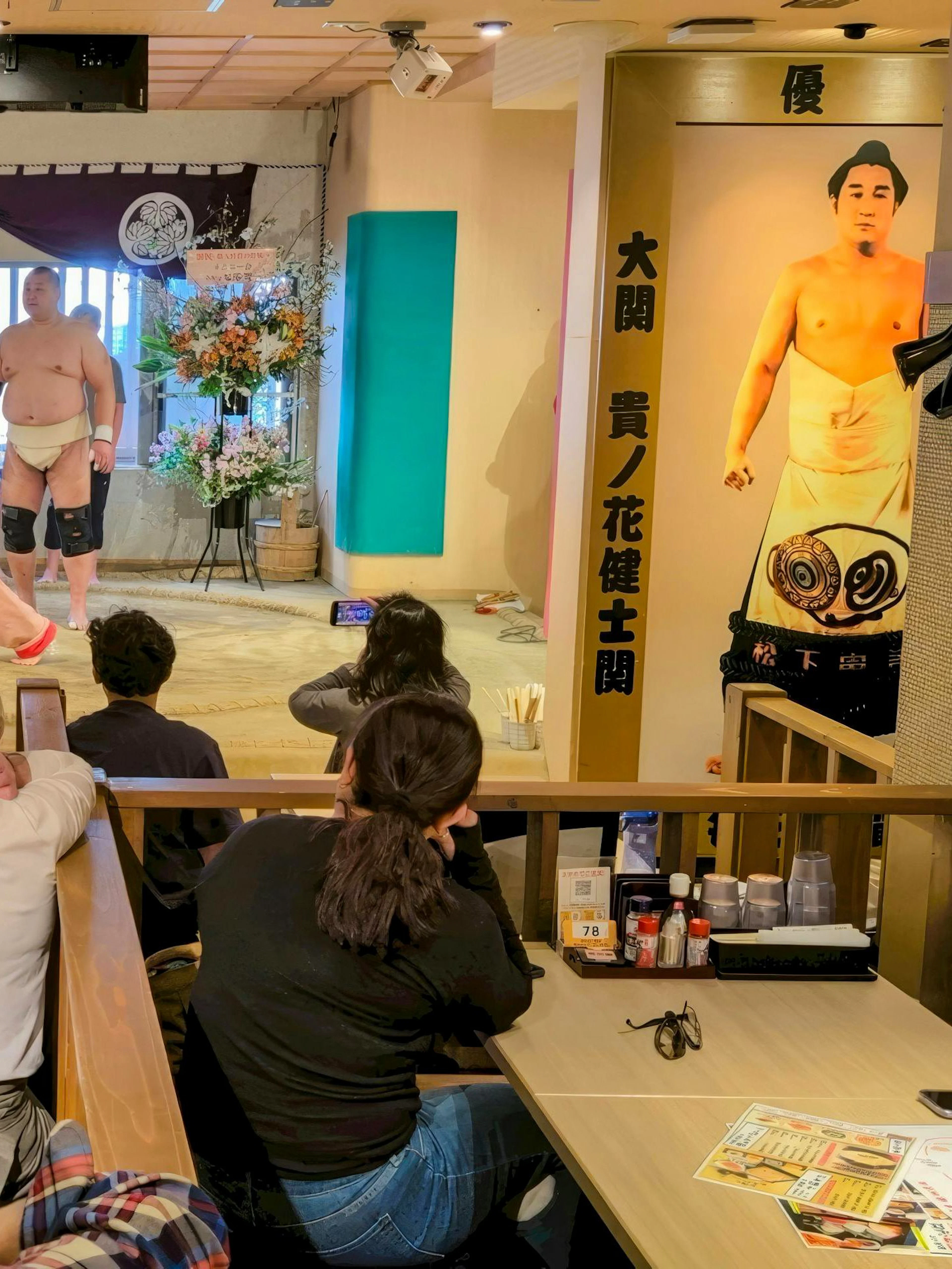 Sumo wrestlers performing at Tokyo Family Sumo Workshop with audience watching.