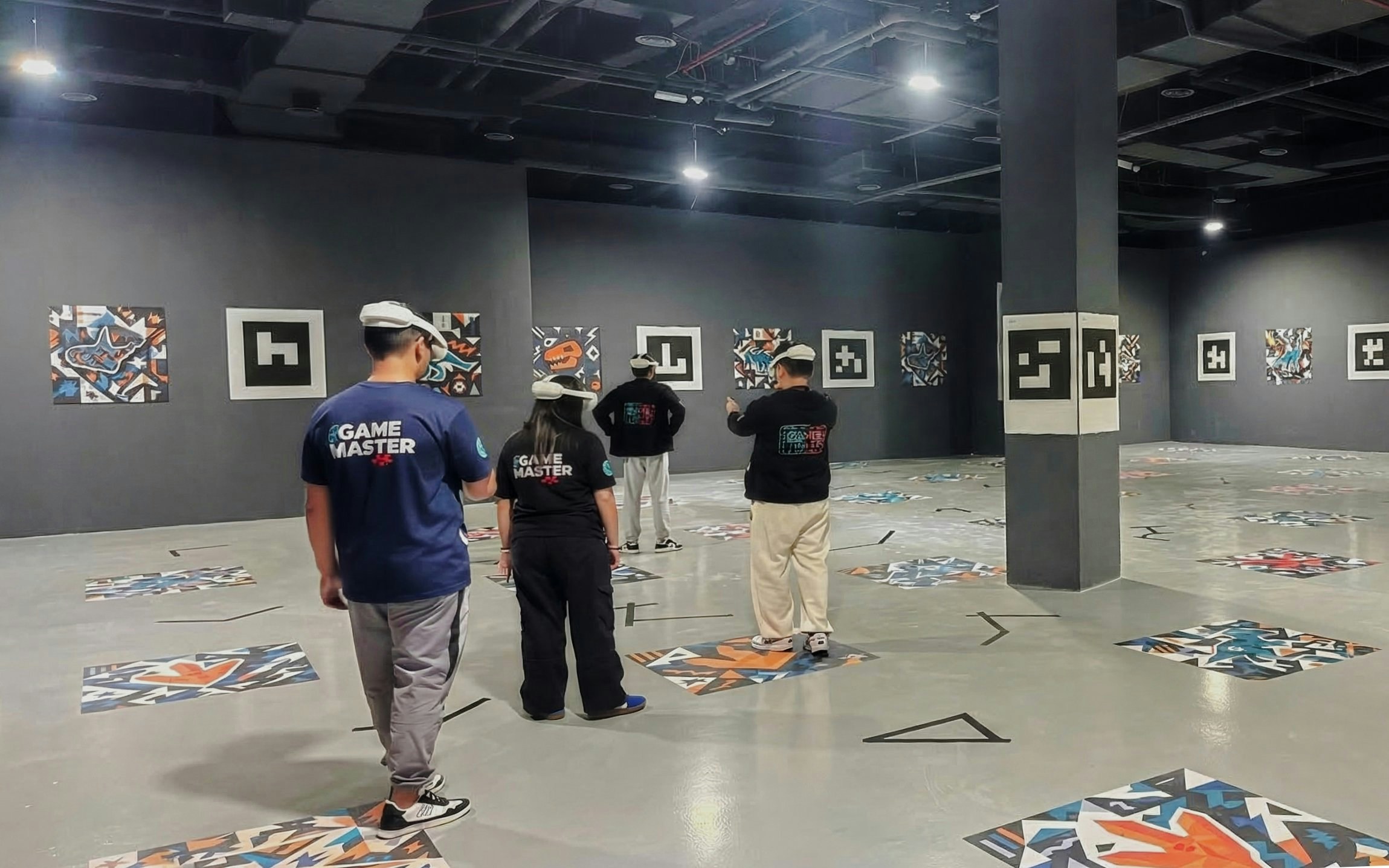 Visitors in VR headsets exploring Dinosaurs: The Immersive Odyssey exhibit with wall art.