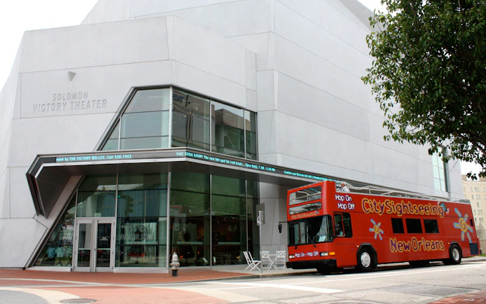 Solomon Victory Theater with New Orleans Hop-On Hop-Off bus in front.