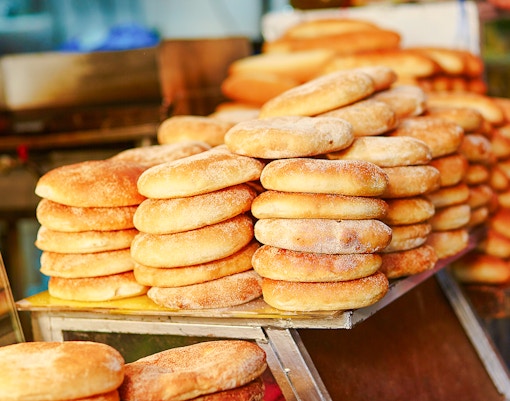 Stacks of traditional bread at a market.
