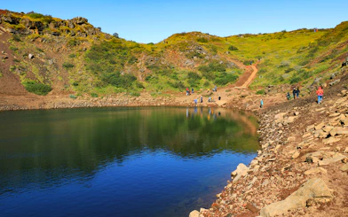 Kerid Crater with visitors walking along the path, part of the Golden Circle tour from Reykjavik.
