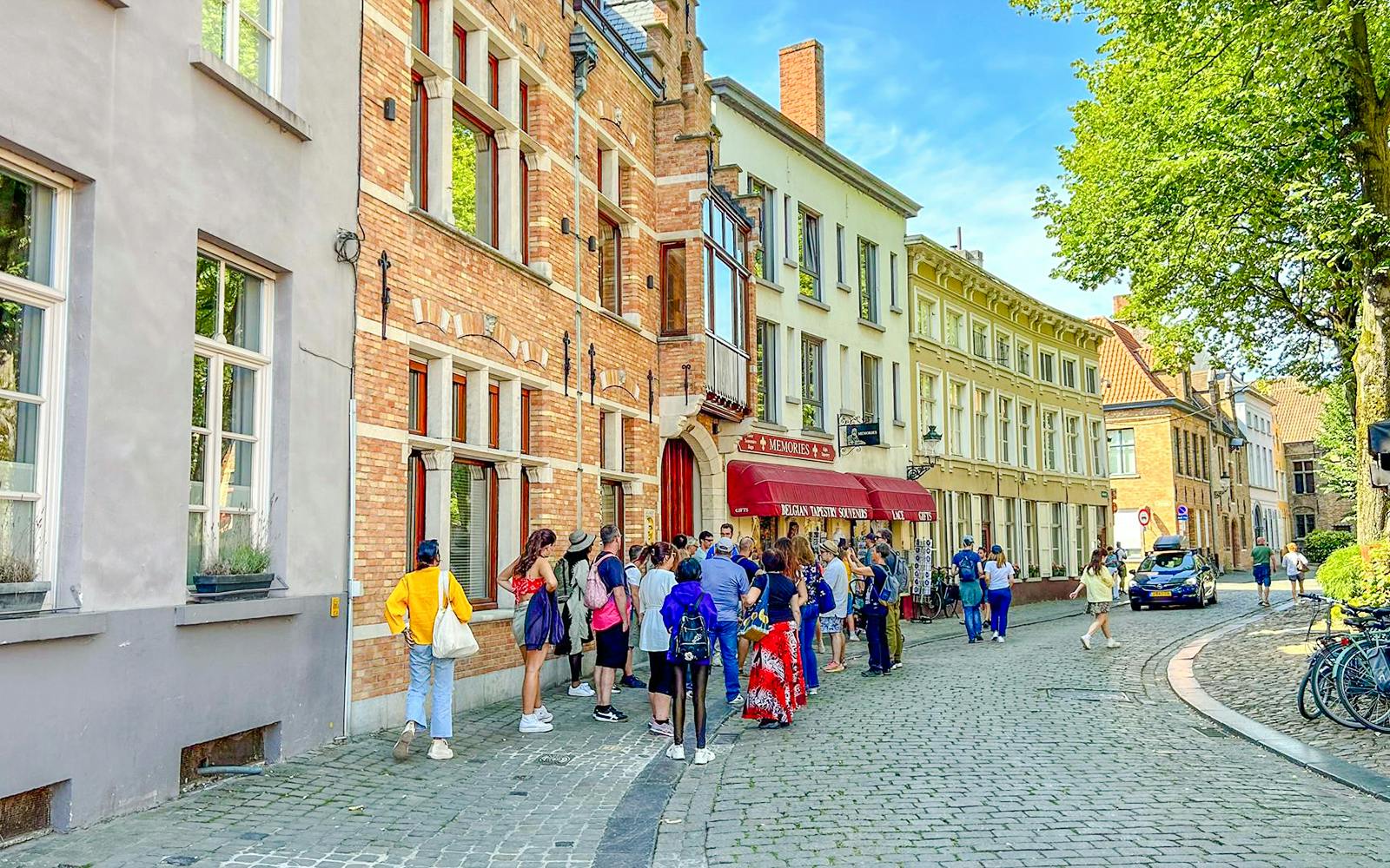 Tour group exploring historic street in Bruges, Belgium.