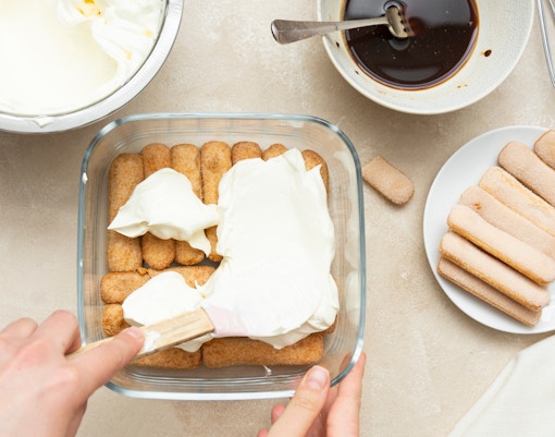 Tourists learning to make tiramisu in a Rome cooking class.