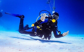 Scuba diver underwater in Sharm El Sheikh giving an OK sign during a guided dive.
