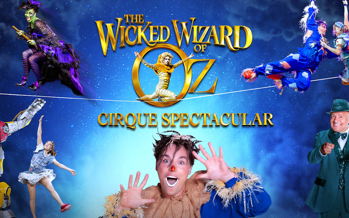 Wicked Wizard of Oz Cirque Spectacular performers in colorful costumes on a starry background.