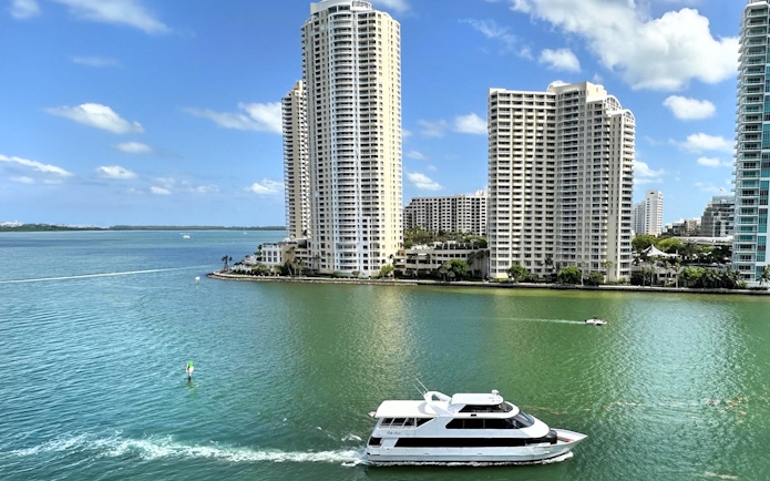 Boat cruising near high-rise buildings on Miami's waterfront.
