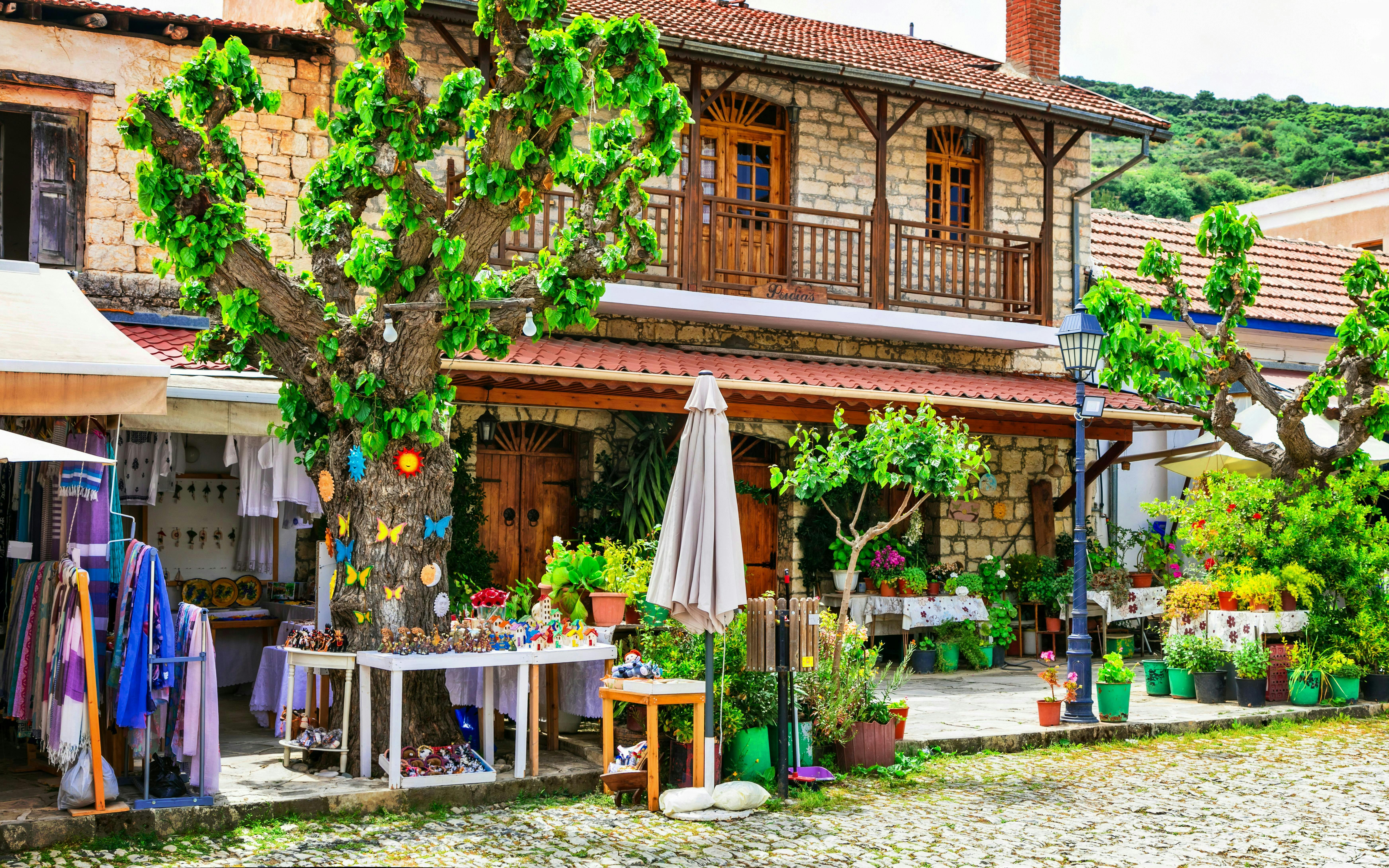 Traditional stone house and market stalls in Omodos village, Cyprus.