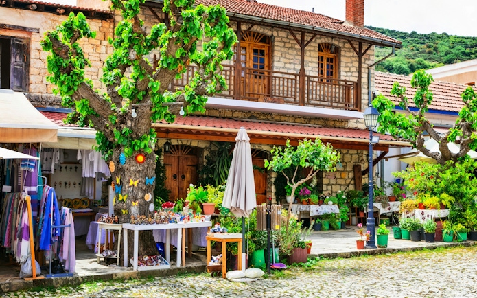 Traditional stone house and market stalls in Omodos village, Cyprus.