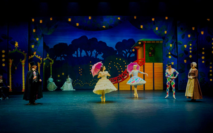 Ballet dancers performing The Nutcracker at Tivoli Gardens with colorful costumes and set.