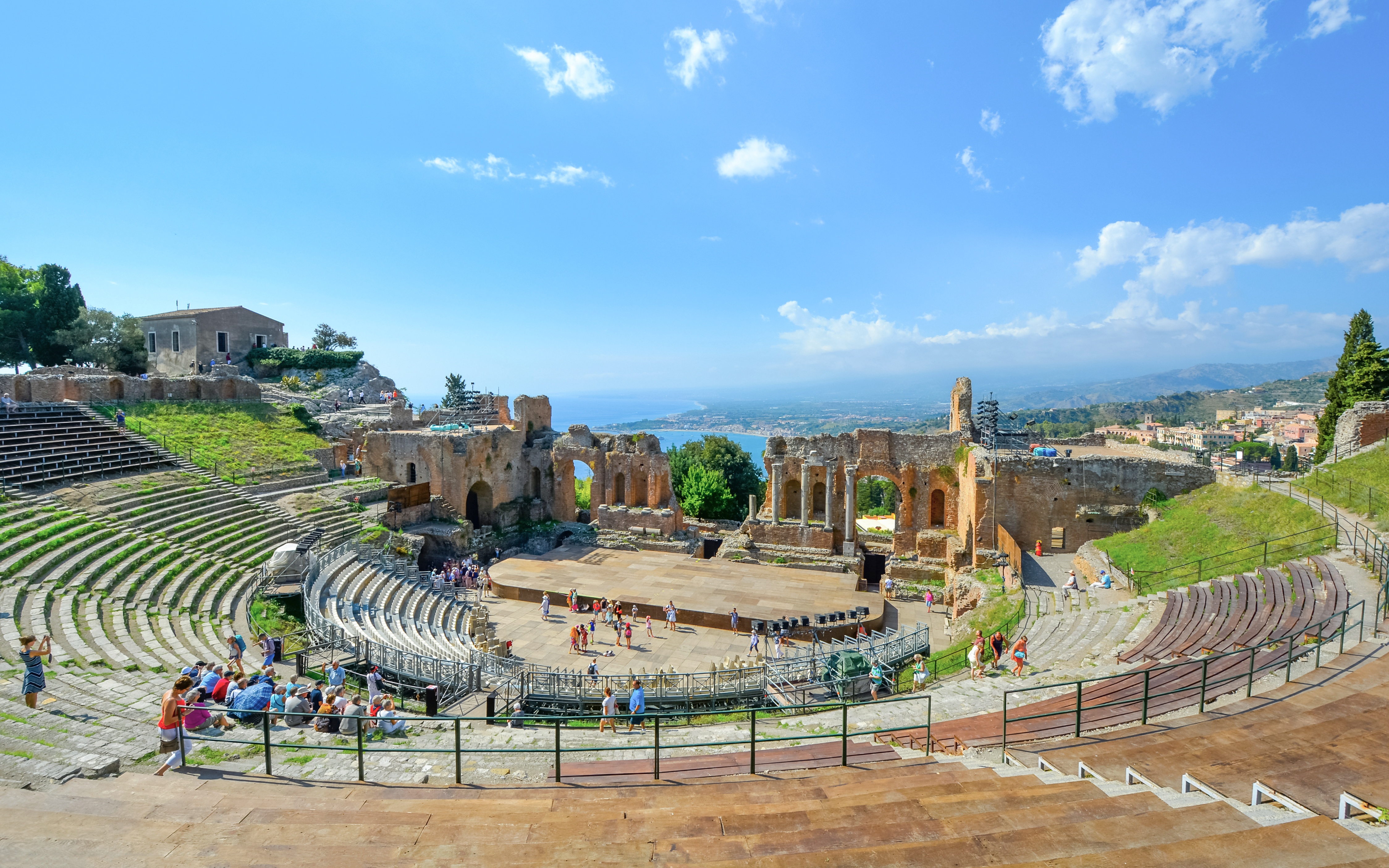 Greek Theatre in Taormina, Sicily with Mediterranean Sea view in background.