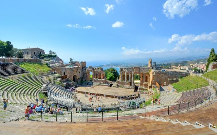 Greek Theatre in Taormina, Sicily with Mediterranean Sea view in background.