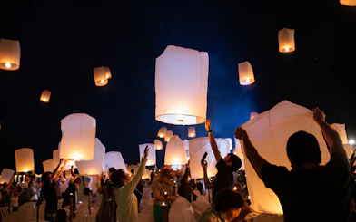 Lanterns released into night sky at Yeepeng Lanna Festival 2023, Chiang Mai.