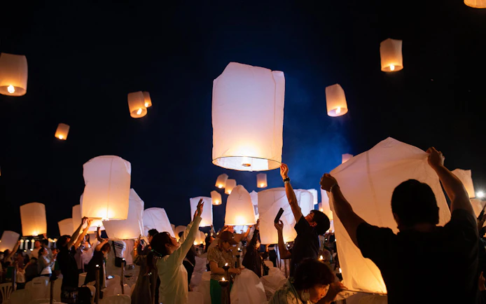 Lanterns released into night sky at Yeepeng Lanna Festival 2023, Chiang Mai.