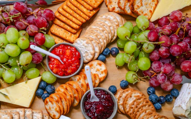 Platter with grapes, crackers, cheeses, and dips for guests on the cruise.